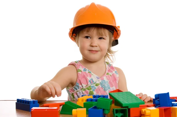 The little girl in a helmet plays — Stock Photo, Image