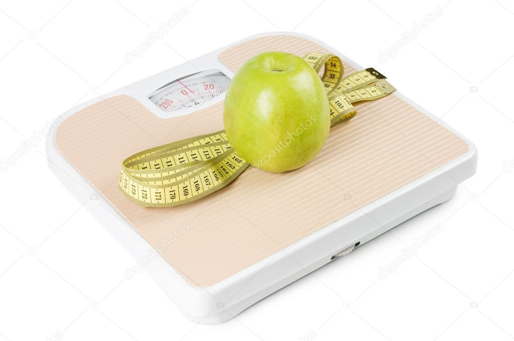 Scale, tape and apple on white background