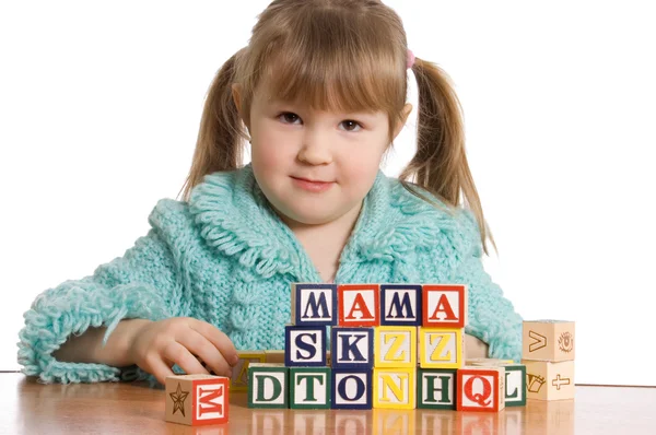 The little girl plays cubes — Stock Photo, Image
