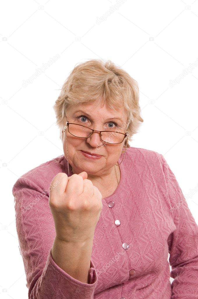 The elderly woman shows a fist