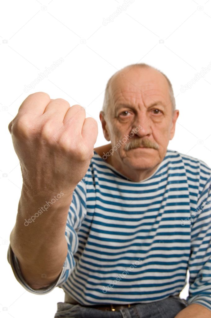 The elderly man threatens with a fist