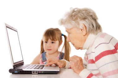 The grandmother with the grand daughter at the computer clipart