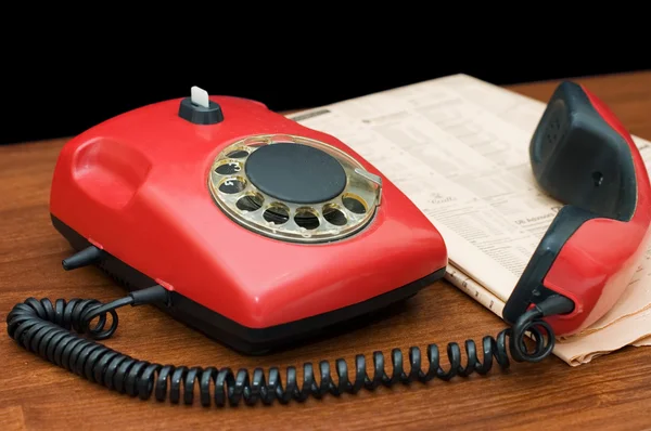 Red phone on a wooden table — Stock Photo, Image