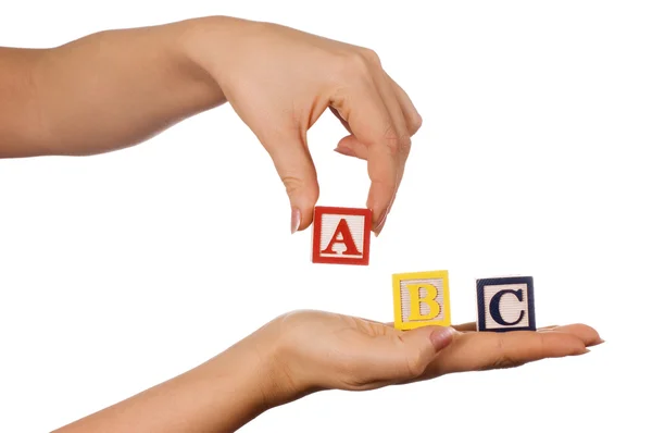 The hand holds a cube with letters — Stock Photo, Image