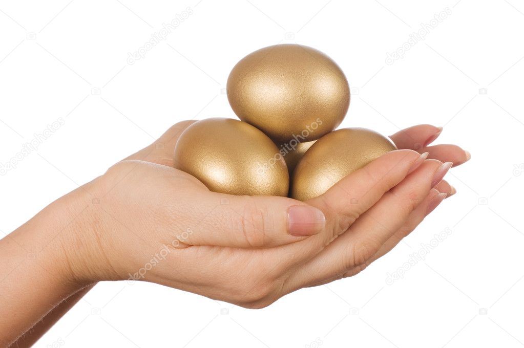 Golden egg in the hand isolated