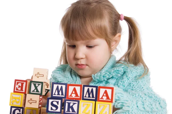 The little girl plays cubes — Stock Photo, Image