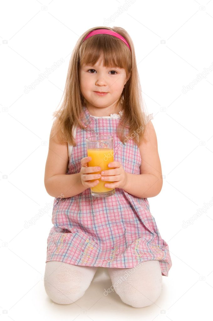 The little girl drinks orange juice