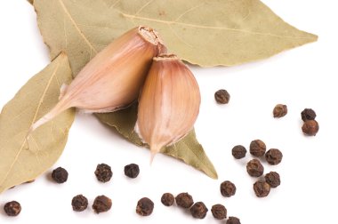 Black Peppercorns with garlic and a bay leaf clipart