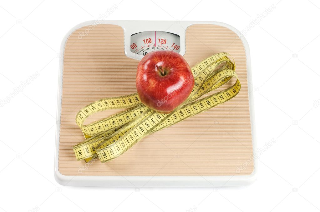 Scale, tape and apple on white background