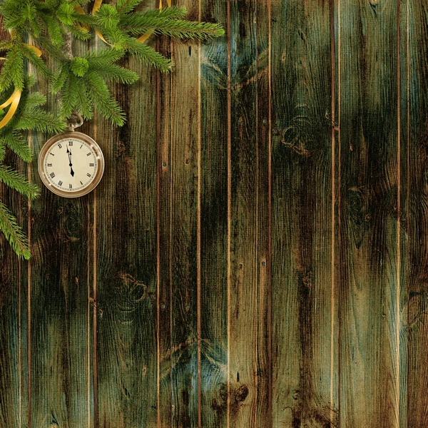 Kort för en semester med grenar och klockan på den trä backg — Stockfoto