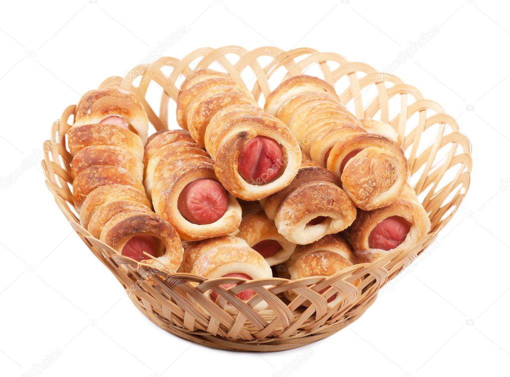 Sausage rolls in pastry in a wicker basket