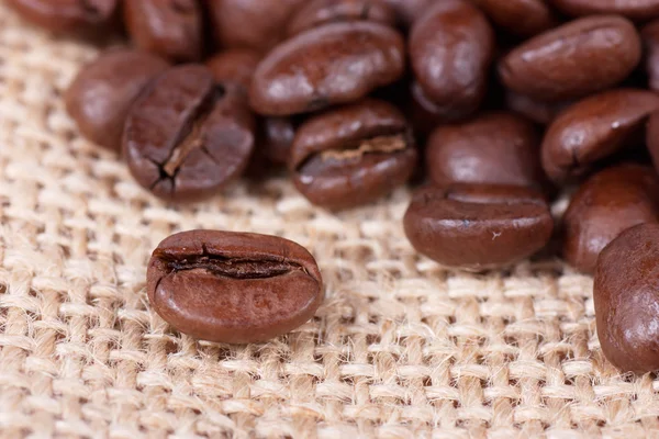 Coffee beans on sack — Stock Photo, Image