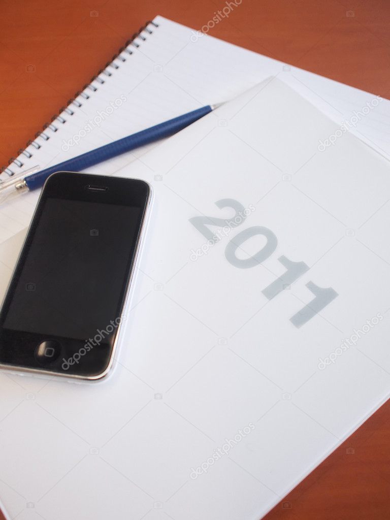 Items including schedule, mobile phone and notebook for business in 2011
