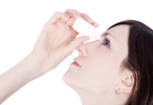 stock image Woman dripping eye with eyes drops