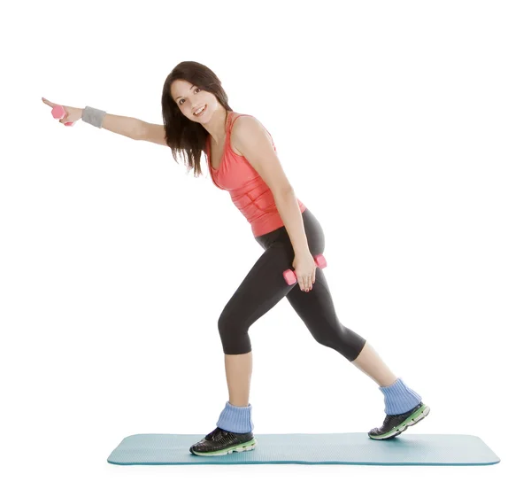 Attraktive junge Frau mit Fitnesshanteln im Stretching — Stockfoto
