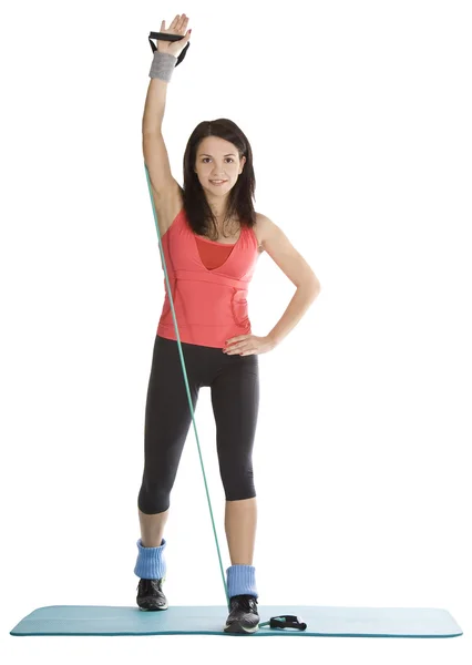 Attractive young female with fitness expander in stretching — Stock Photo, Image