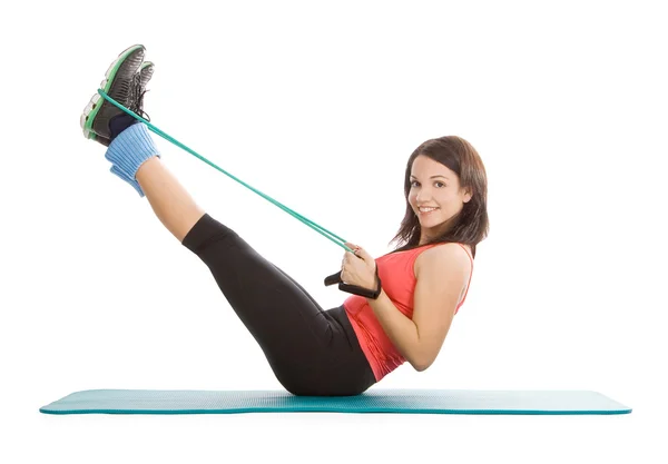 Attractive young female with fitness expander in stretching — Stock Photo, Image