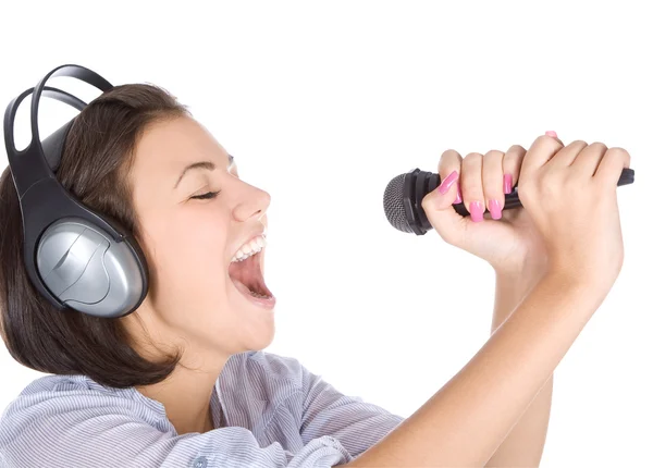 Caucasian female singing into microphone. — Stock Photo, Image