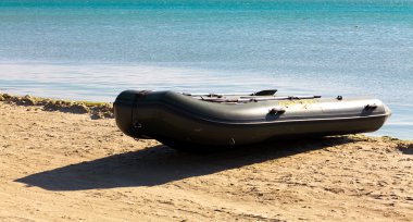 Inflatable boat on seacoast clipart
