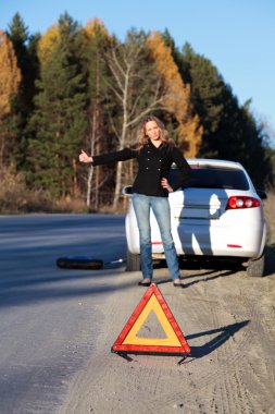 Woman trying to catch someone who may help her clipart