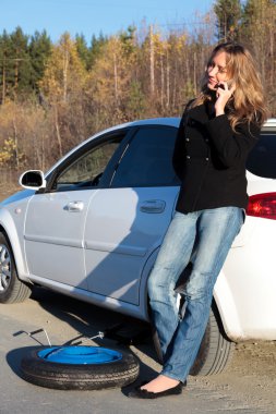 Young woman standing by her damaged car clipart