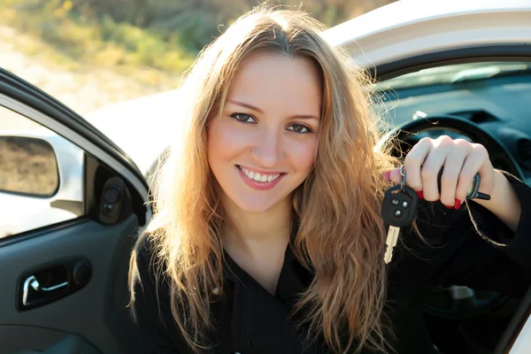 Happy owner of a new car showing a key. — Stock Photo, Image