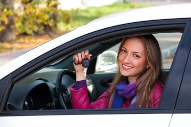 Woman Showing The Key Of Her New Car clipart