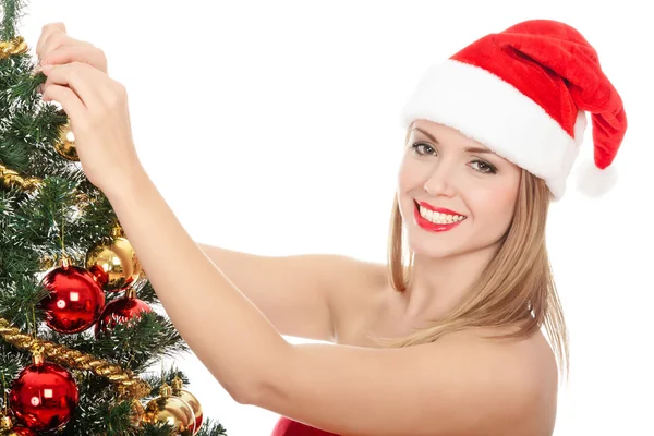 Жінка одягнені як Санта Клаус стоїть поруч з ялинку — стокове фото