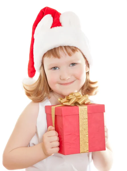 Bébé fille dans le chapeau du Père Noël tenant son cadeau de Noël — Photo