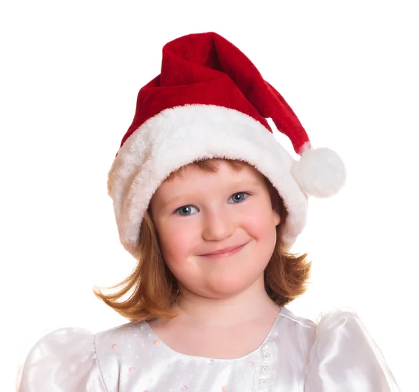 Portrait of pretty christmas girl in white dress and santa hat — Stock Photo, Image