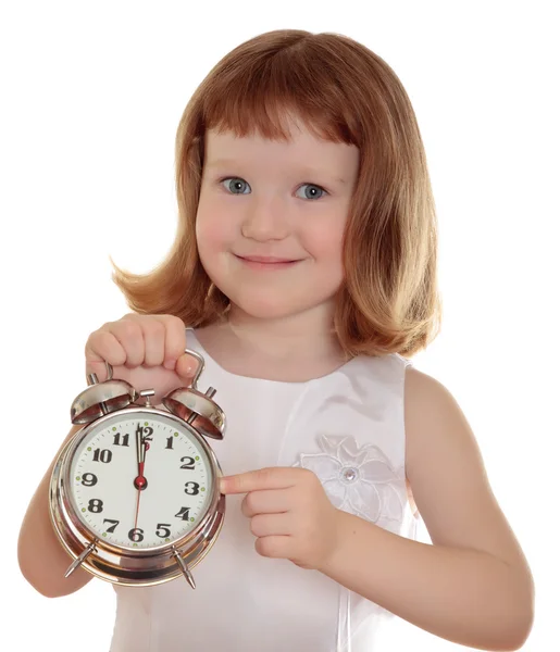 Portrait of little girl holding alarm clock, isolated over white — Stock Photo, Image
