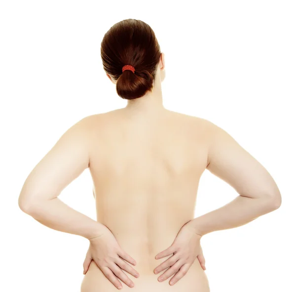 Donna massaggiare il dolore alla schiena isolato su uno sfondo bianco — Foto Stock