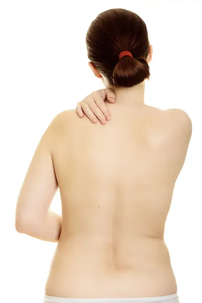 Frau massiert Schmerzen zurück isoliert über weißem Hintergrund — Stockfoto
