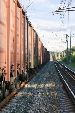 Railway tracks with freight train wagons clipart