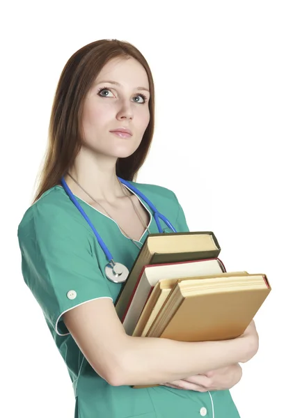 ユニフォーム 白い背景で隔離の本の緑の親切な女性看護師の肖像画 — ストック写真