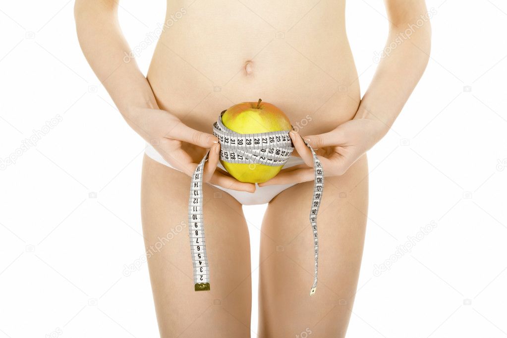 Young vegetarian woman measuring her waist