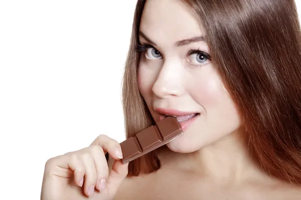 Pretty young woman eating chocolate — Stock Photo, Image