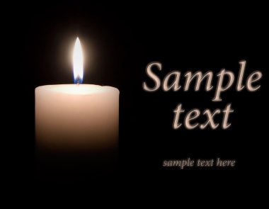 White wax candle is lit in the dark clipart