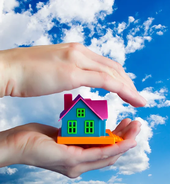 stock image Toy house in human hands - Against the sky