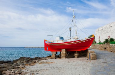 The famous red boat-restaurant on the island of Mykonos clipart