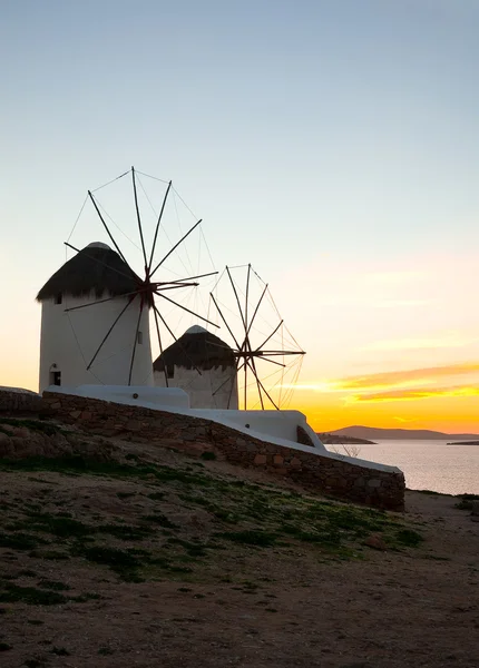 Ett antal berömda väderkvarnar på ön mykonos i solnedgången. — Stockfoto
