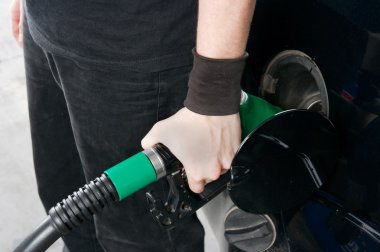 Refueling a car at a petrol station clipart