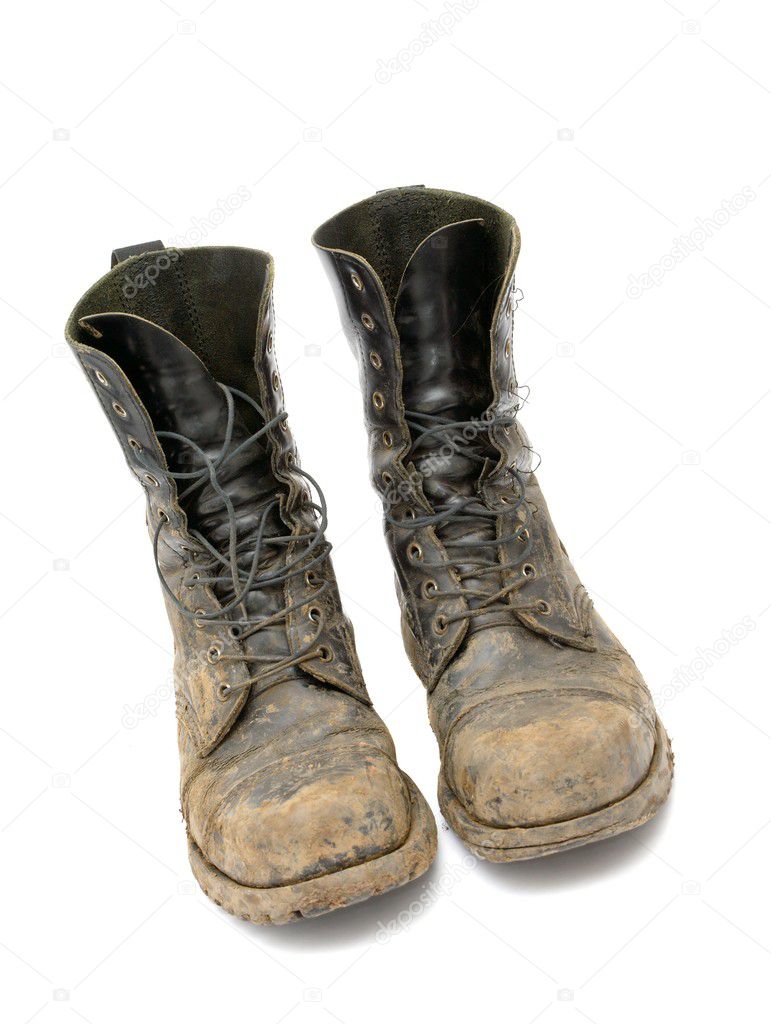 Very dirty boots isolated on white background