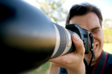 Crazy photographer using telephoto lens clipart