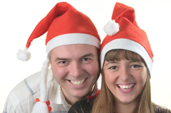 Pai e filha está nos bonés de Papai Noel — Fotografia de Stock
