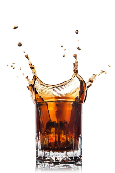 Splash of cola in glass isolated on white — Stockfoto