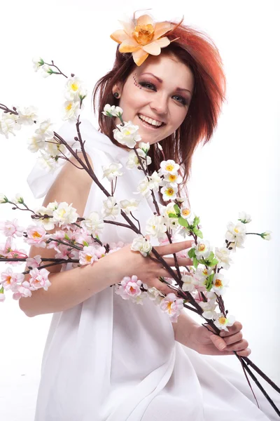 Portrait of beautiful woman with spring flowers on white — Stock Photo, Image