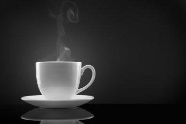 White cup with hot liquid and steam on black clipart