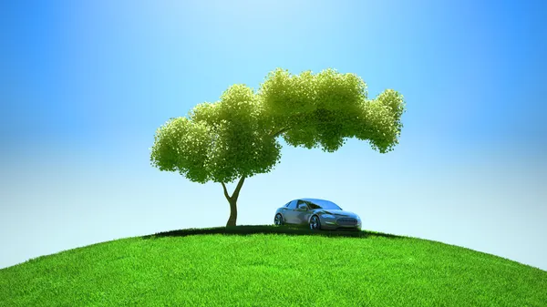 Modern vehicle under tree on green fileld