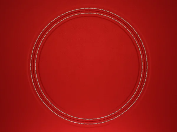 Красный сшитый круг на кожаном фоне — стоковое фото